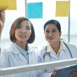 Image closeup-of-two-medical-workers-putting-memo-stickers from Freepik