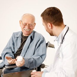 Image male-doctor-and-old-man-on-wheelcha from Freepick